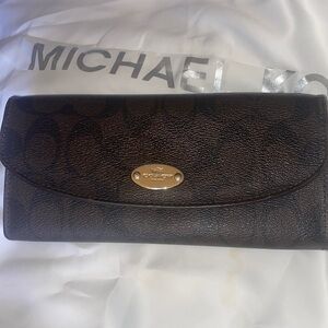 Coach wallet, dark brown and burgundy inside with a few scuffs only on inside.